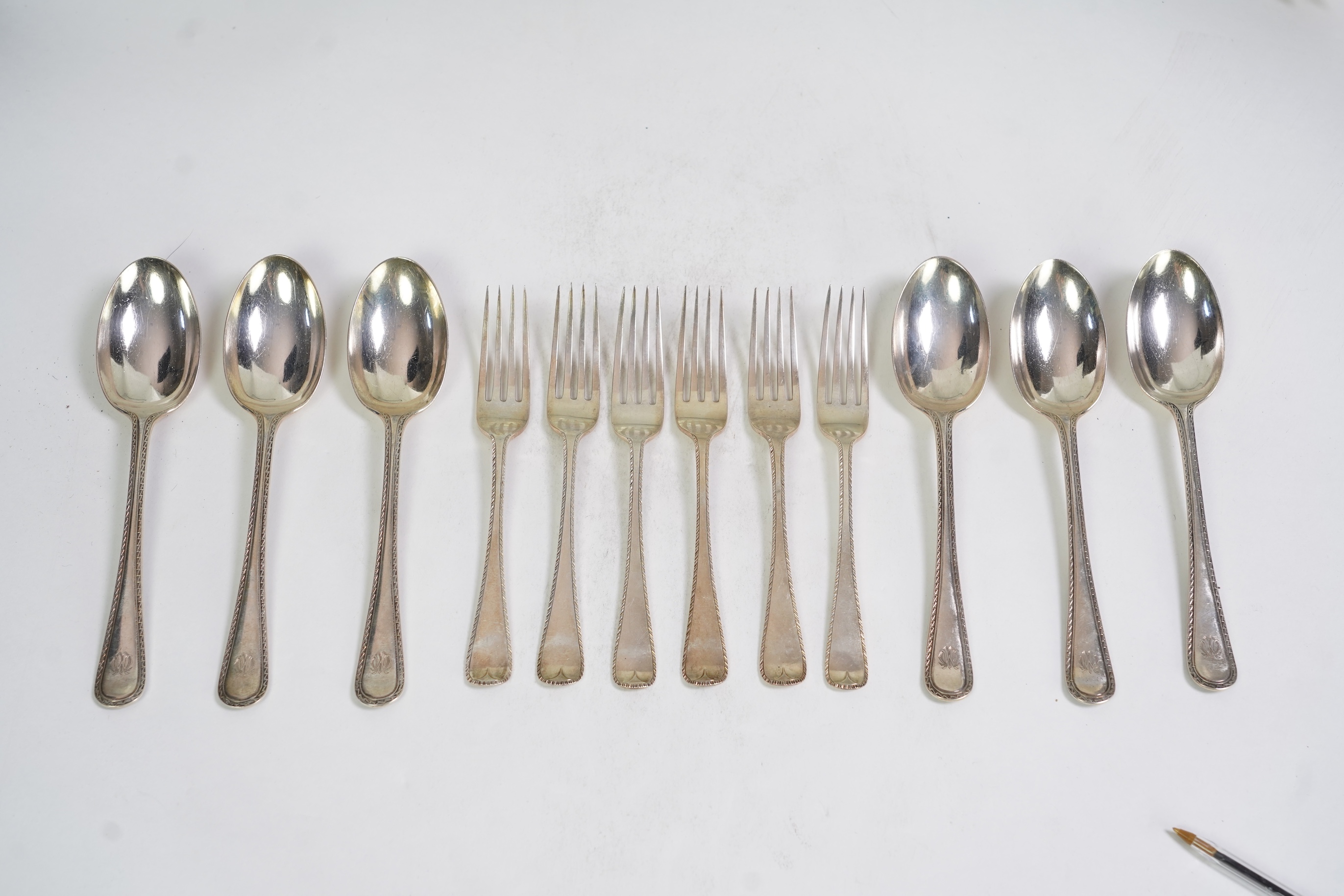 A set of six George V fancy Old English pattern table spoons by Elkington & Co, Birmingham, 1919, 22.2cm, together with a set of six fancy Hanoverian pattern table forks, Goldsmiths & Silversmiths Co Ltd, London, 1918, 3
